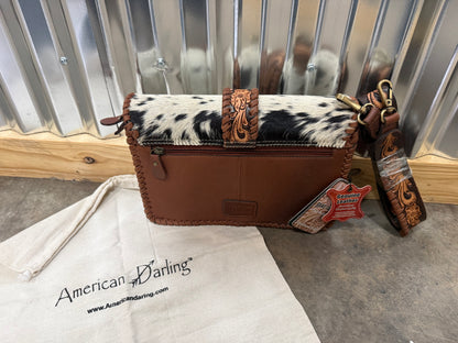 Hair-on cowhide crossbody bag with tooled leather strap and trim
