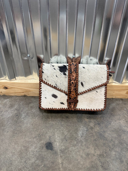 Hair-on cowhide crossbody bag with tooled leather strap and trim